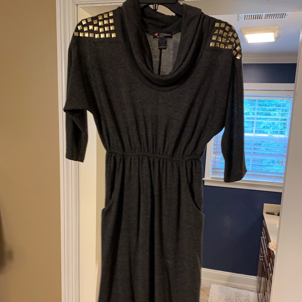 Grey sweater dress with gold accents.